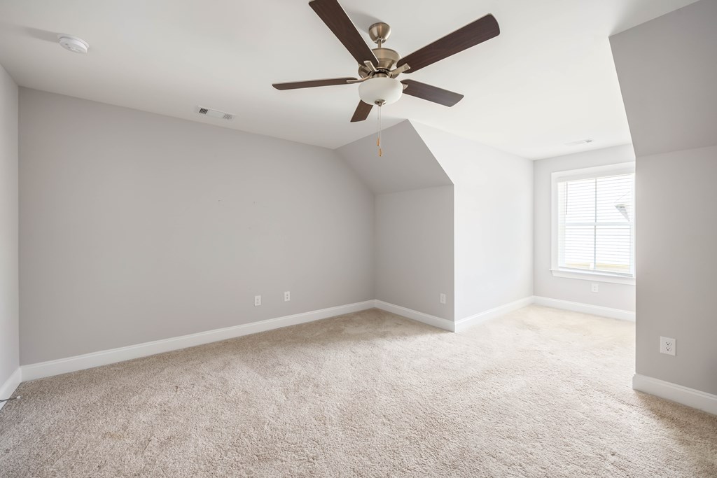 50 Ivy Loop Phenix City, AL 36867 - Photo 20 of 23 an empty room with a ceiling fan and window