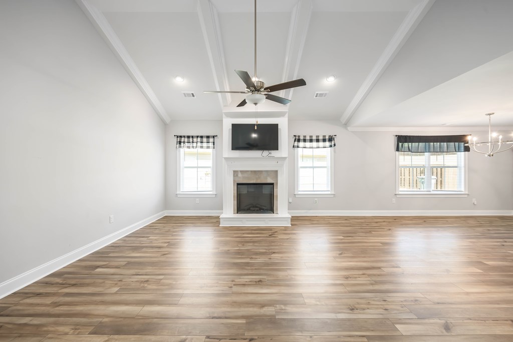 50 Ivy Loop Phenix City, AL 36867 - Photo 5 of 23 an empty room with wooden floor fireplace and windows