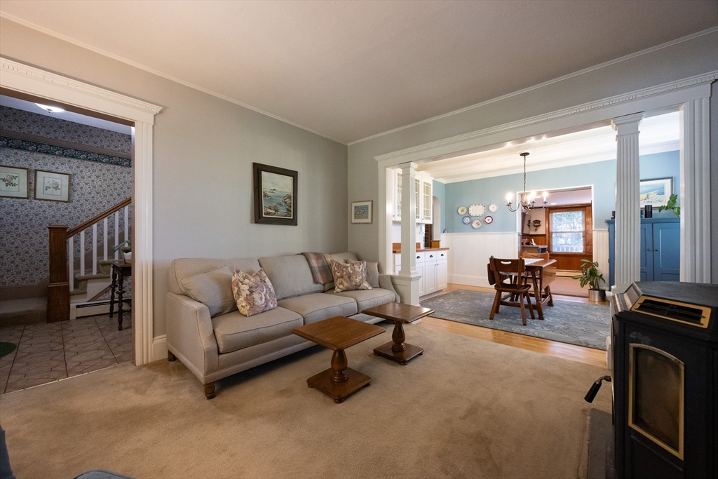 41 Roy Street Swampscott, MA 01907 - Photo 18 of 42 a living room with furniture and a dining table with garden view