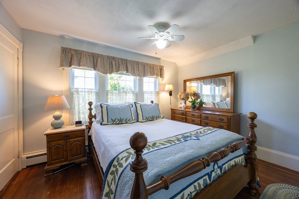 41 Roy Street Swampscott, MA 01907 - Photo 22 of 42 a bedroom with a bed and large windows