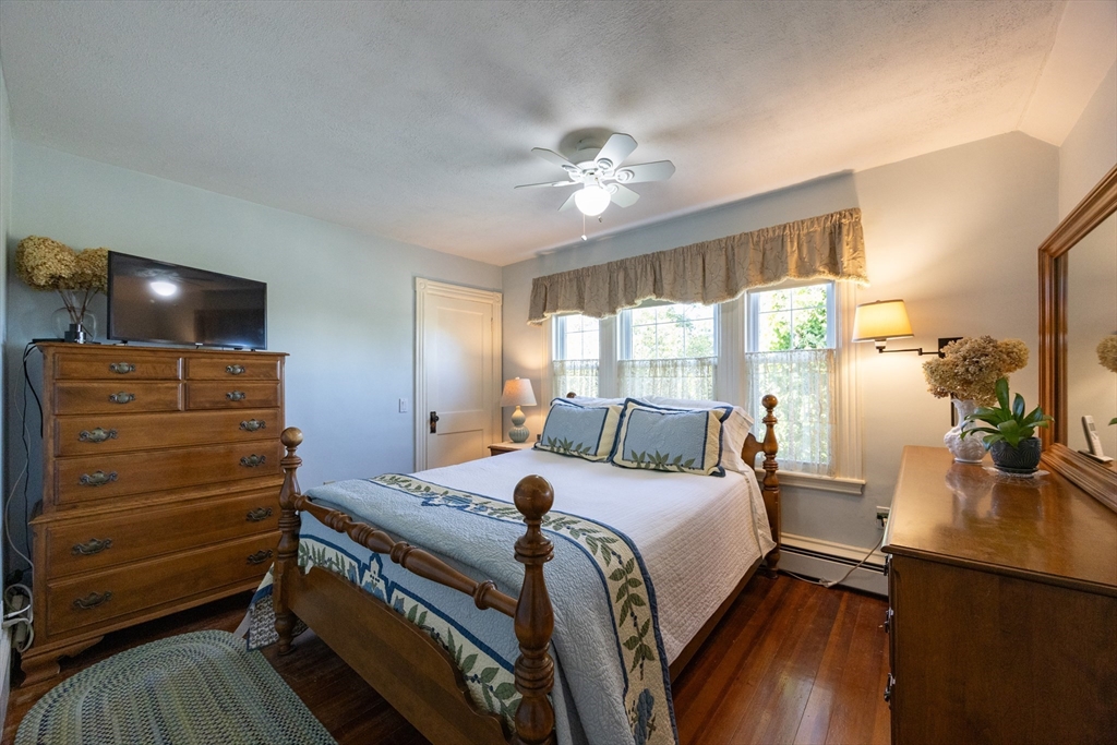 41 Roy Street Swampscott, MA 01907 - Photo 23 of 42 a bedroom with a bed and a flat tv screen on dresser