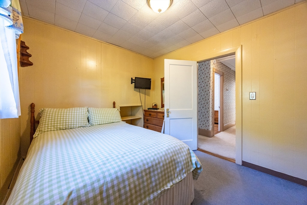 41 Roy Street Swampscott, MA 01907 - Photo 24 of 42 a bedroom with a bed and wooden floor