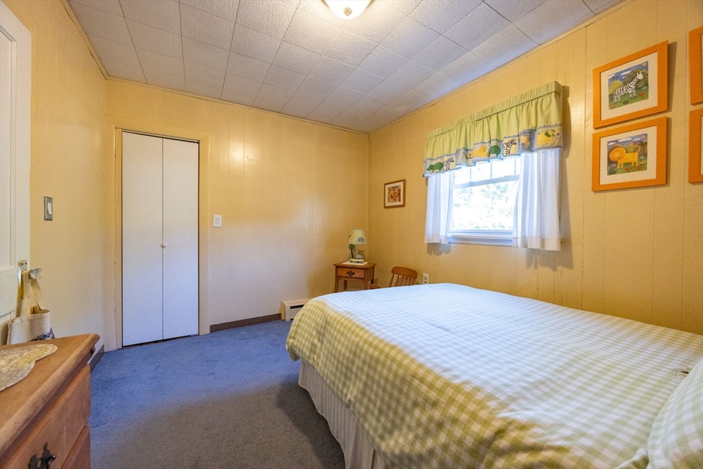41 Roy Street Swampscott, MA 01907 - Photo 25 of 42 a bedroom with a bed and wooden floor