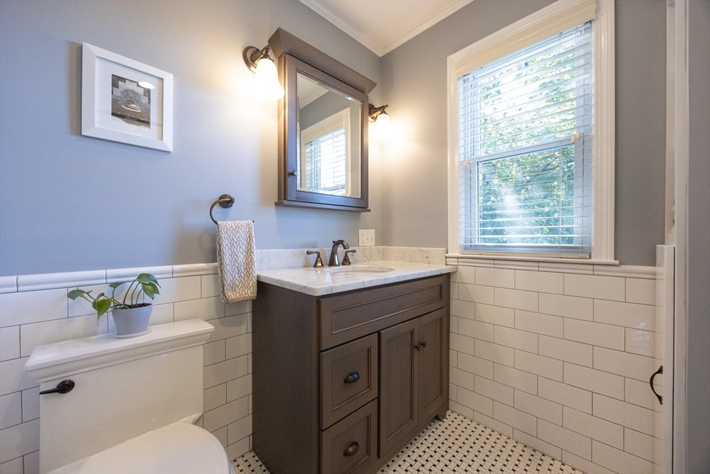 41 Roy Street Swampscott, MA 01907 - Photo 30 of 42 a bathroom with a sink vanity granite toilet and a window