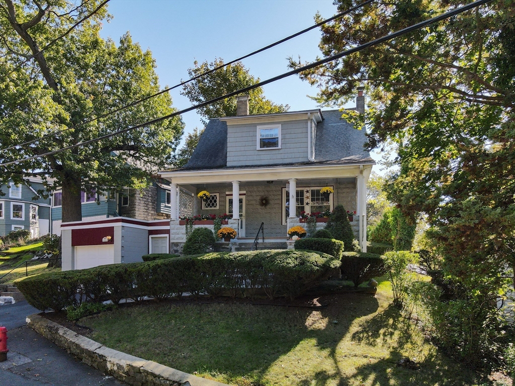 41 Roy Street Swampscott, MA 01907 - Photo 32 of 42 a front view of a house with a garden and yard