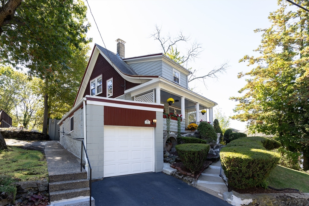 41 Roy Street Swampscott, MA 01907 - Photo 40 of 42 a view of a house with a small yard plants and large tree