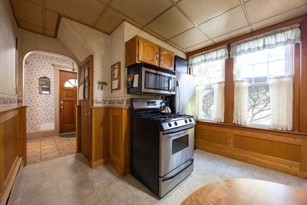 41 Roy Street Swampscott, MA 01907 - Photo 8 of 42 a kitchen with stainless steel appliances granite countertop a stove a refrigerator and a view of living room