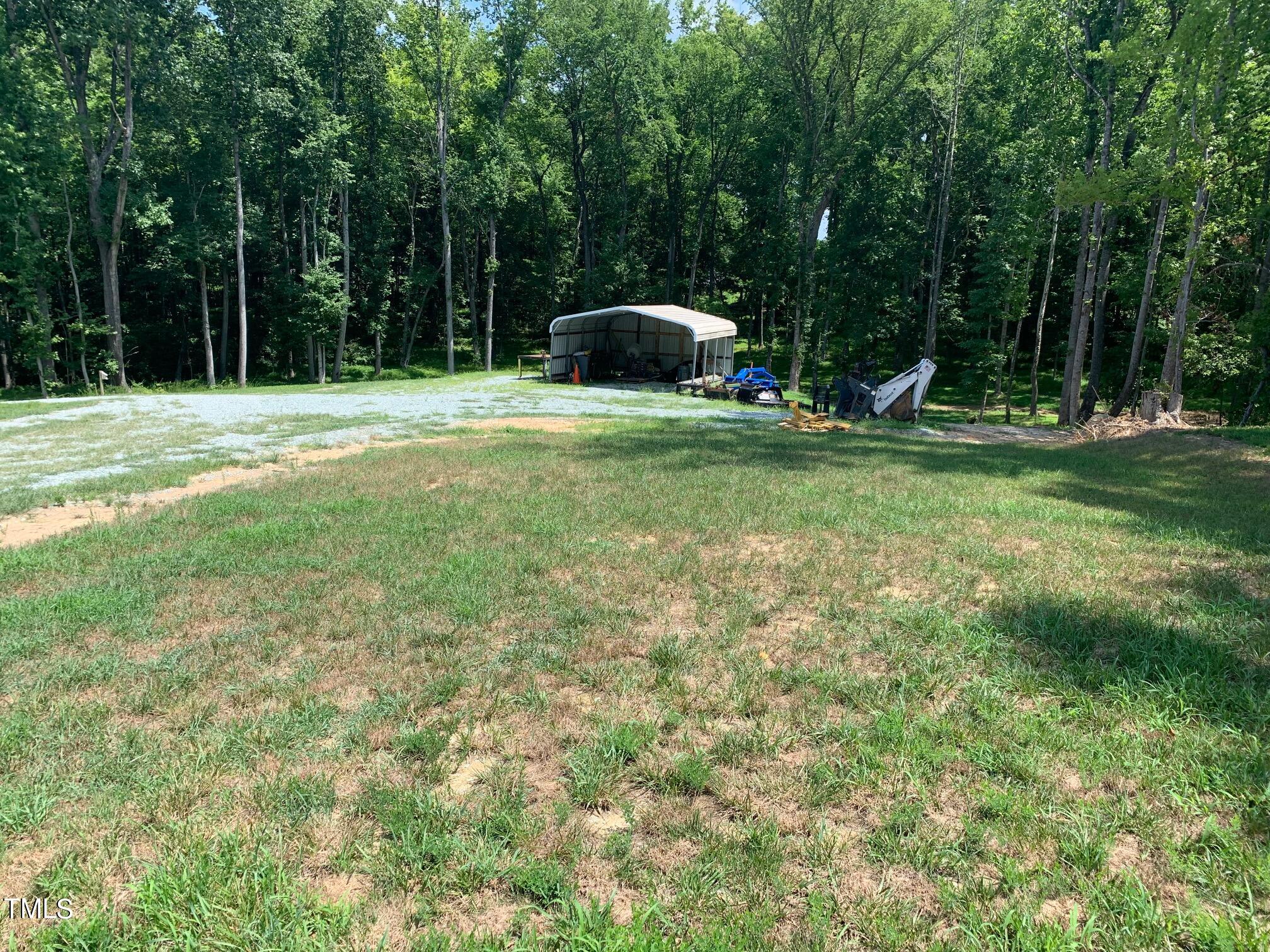 150 Smith Hill Lane Roxboro, NC 27574 - Photo 2 of 6 a backyard of a house with slide and trees