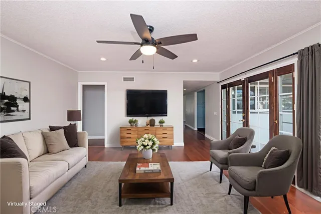 a living room with furniture a flat screen tv and a large window