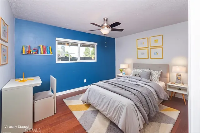 a bedroom with a bed and a painting on the wall