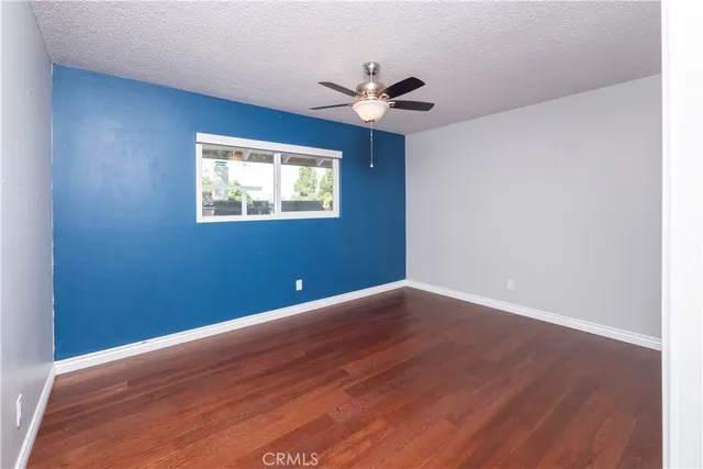 a view of an empty room and wooden floor