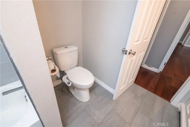 a white toilet sitting next to a sink