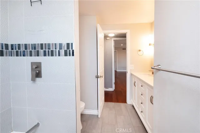 a bedroom with a bed and a potted plant