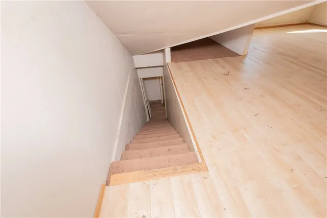 a view of a hallway with stairs