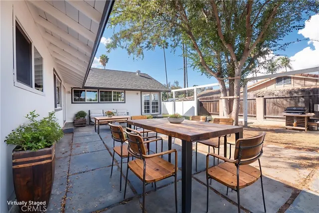 a patio with a table and chairs under an umbrella