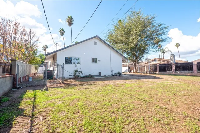 a front view of house with yard and swimming pool
