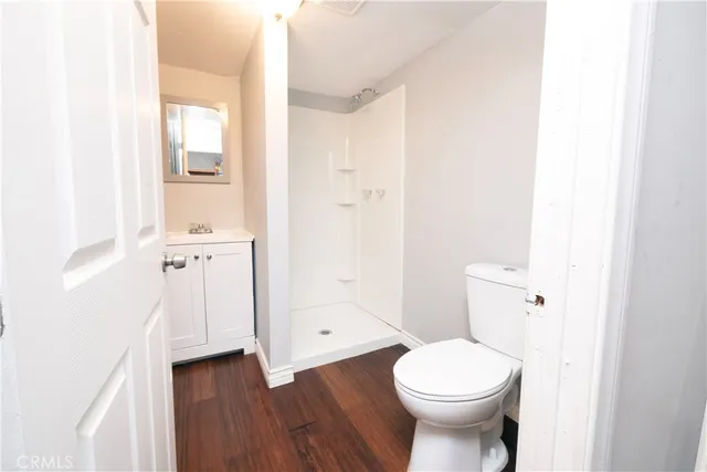 a patio with a table and chairs under an umbrella