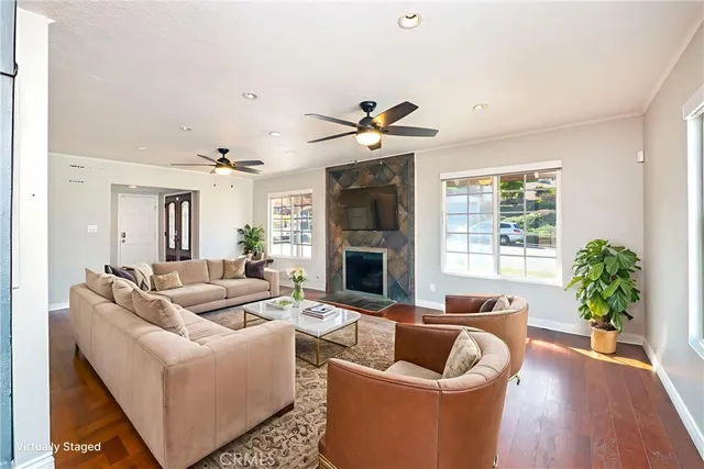 a living room with furniture potted plant and a large window