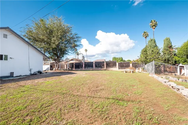 a front view of house with yard and swimming pool