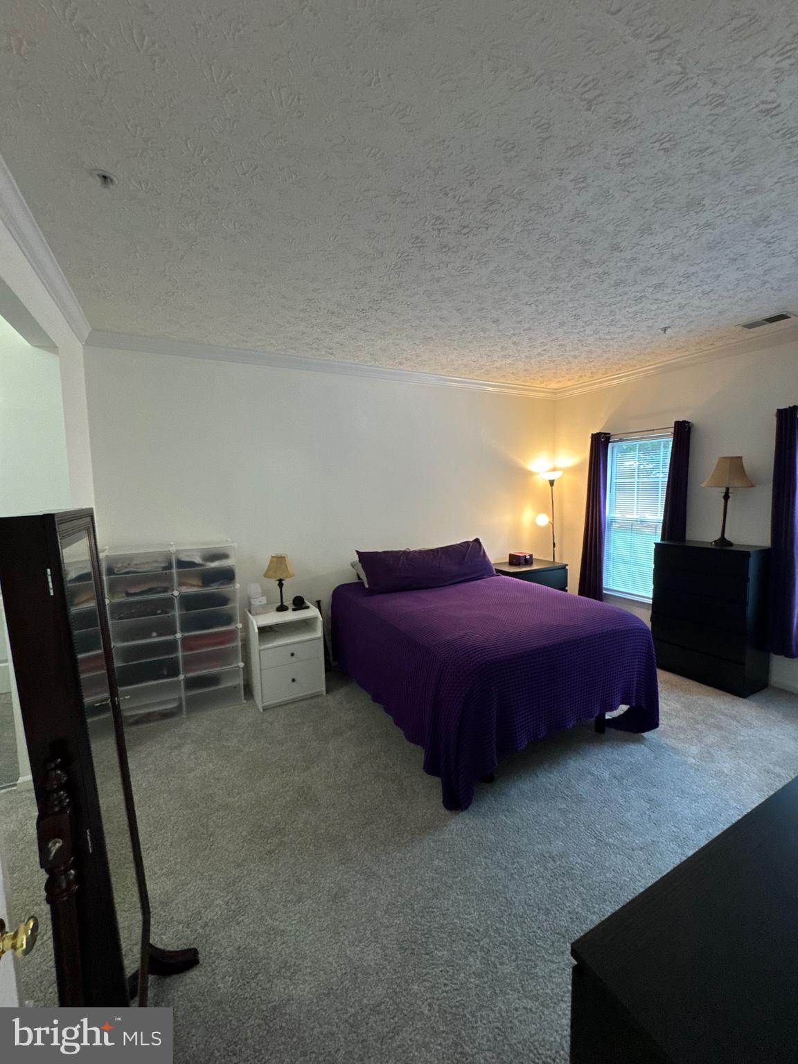 5144 Brightleaf Court, Unit 5144 Rosedale, MD 21237 - Photo 18 of 47 a spacious bedroom with a bed a desk and chair