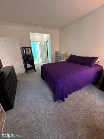 a bedroom with a bed and a mirror