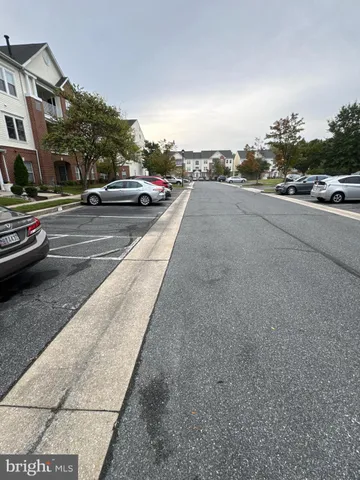 a view of city street with a car parked on the road