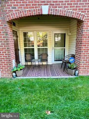 a view of a house with a backyard and a patio