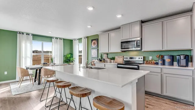 a kitchen with sink a stove and cabinets