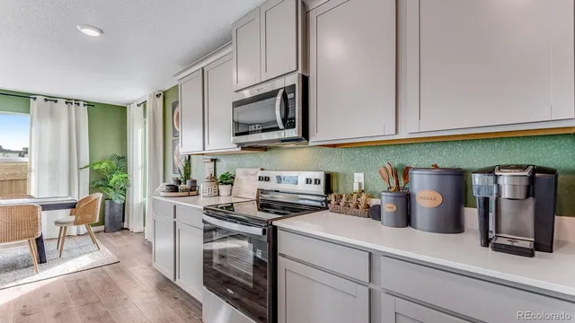 a kitchen with a sink a stove and cabinets