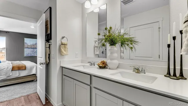 a bedroom with a bed and a refrigerator