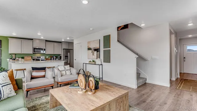 a living room with kitchen island furniture and a wooden floor