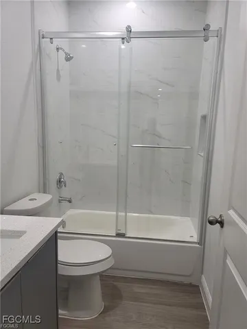 a bathroom with a shower a toilet and sink