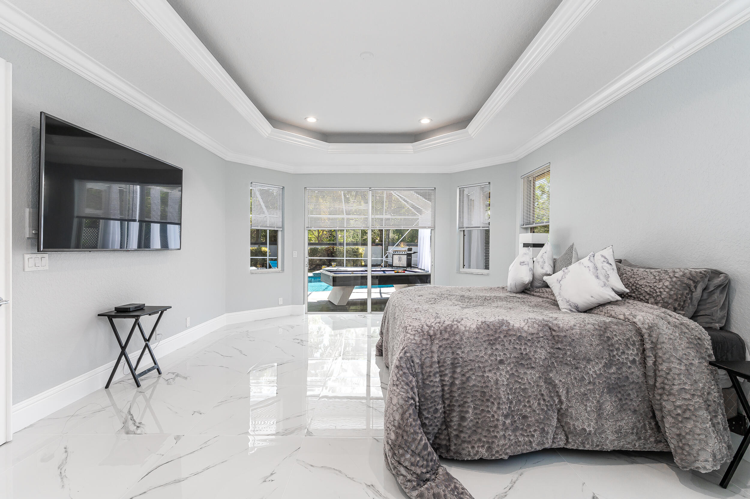 21254 Falls Ridge Way Boca Raton, FL 33428 - Photo 12 of 25 a spacious bedroom with a bed a table and chair