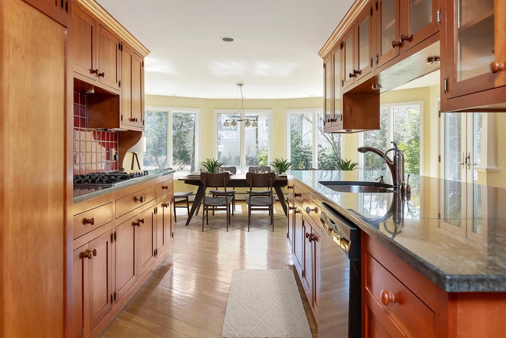 20 Kewadin Road Newton, MA 02468 - Photo 7 of 23 a open kitchen with stainless steel appliances granite countertop a lot of counter space and wooden floors