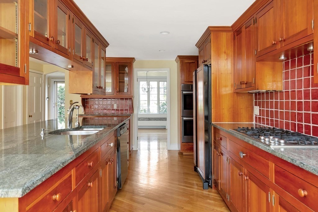 20 Kewadin Road Newton, MA 02468 - Photo 8 of 23 a kitchen with stainless steel appliances granite countertop a sink stove and cabinets