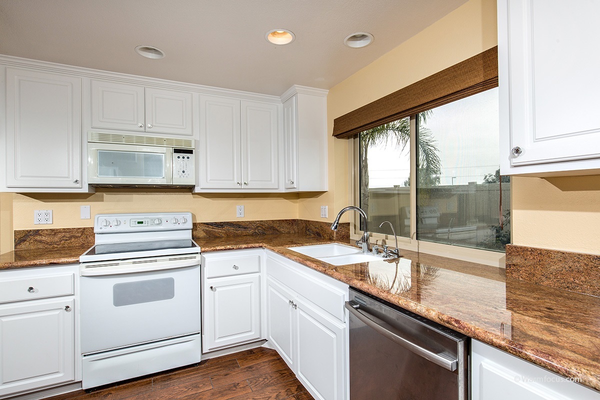 1604 Splitrail Drive Encinitas, CA 92024 - Photo 5 of 25 Bright, white kitchen with crystal knobs and granite counters.