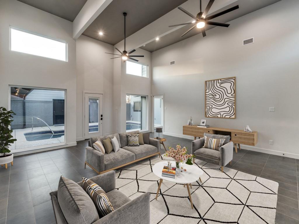 a living room with furniture and a chandelier