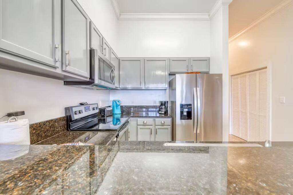 10343 East County Highway 30A, Unit 328 Inlet Beach, FL 32413 - Photo 4 of 16 a kitchen with stainless steel appliances granite countertop a refrigerator and a stove