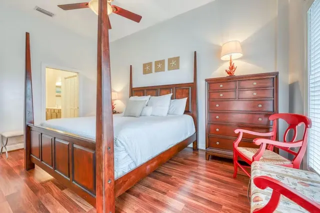 a bedroom with a bed and lamp