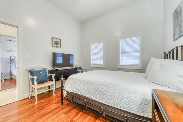 a bedroom with a bed and a flat screen tv