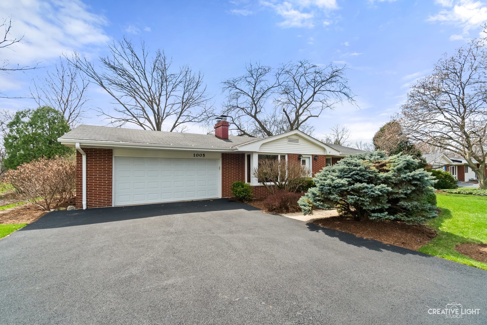 1005 Meadow Lane Elgin, IL 60123 - Photo 2 of 22 a front view of a house with a yard and garage