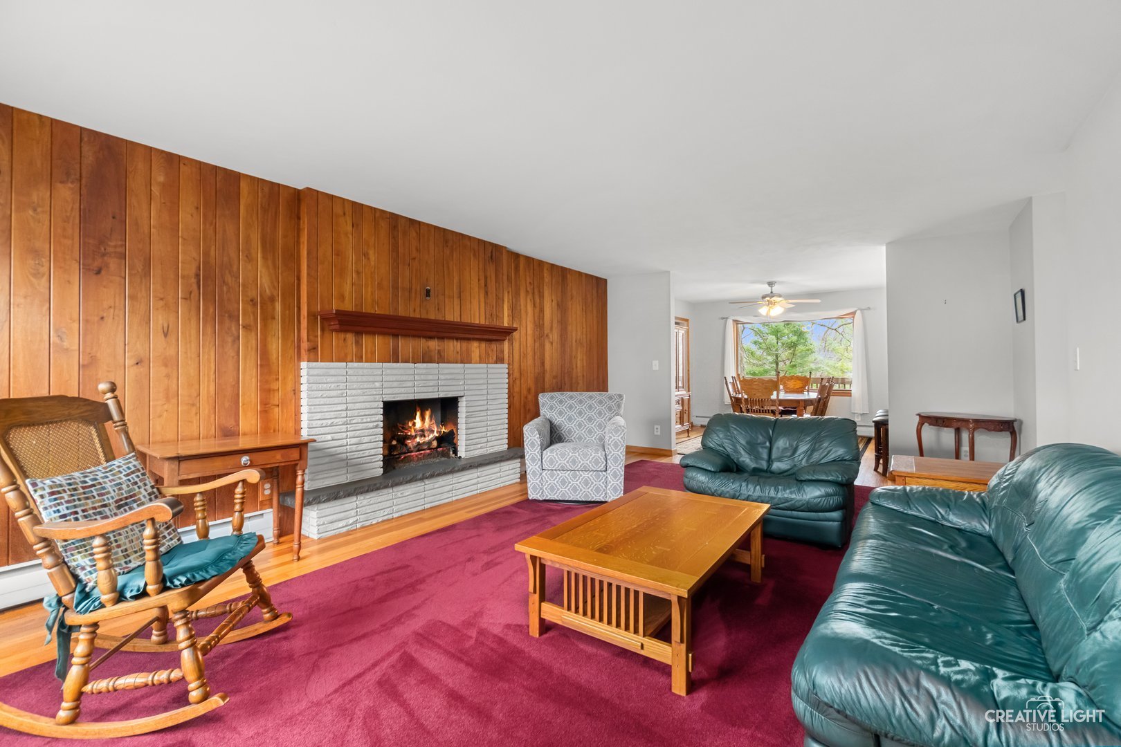 1005 Meadow Lane Elgin, IL 60123 - Photo 3 of 22 a living room with furniture a fireplace and a wooden floor