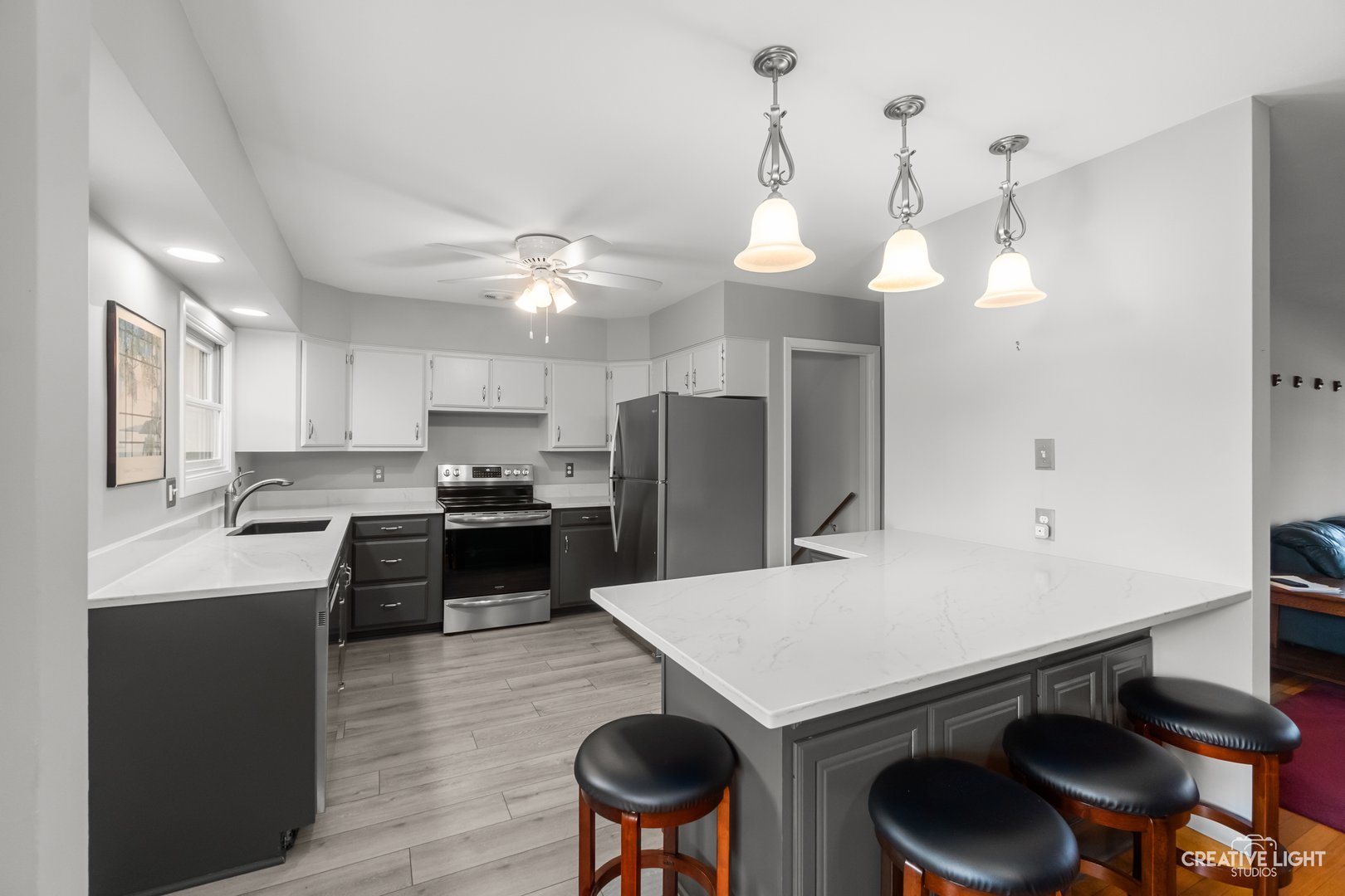 1005 Meadow Lane Elgin, IL 60123 - Photo 6 of 22 a kitchen with a dining table chairs sink and stove