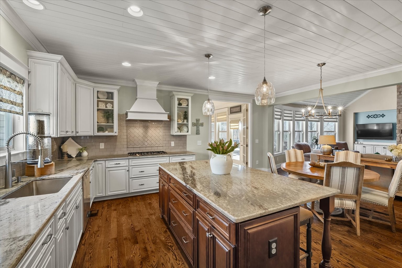 6833 Falls Ridge Lane College Grove, TN 37046 - Photo 22 of 70 a kitchen with granite countertop kitchen island stainless steel appliances a sink stove and table