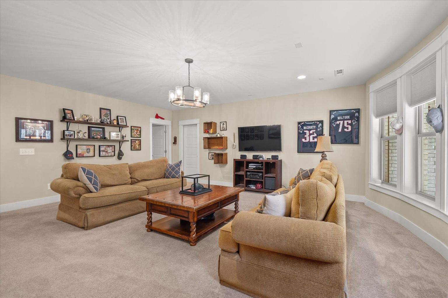 6833 Falls Ridge Lane College Grove, TN 37046 - Photo 56 of 70 a living room with furniture a large window and a flat screen tv