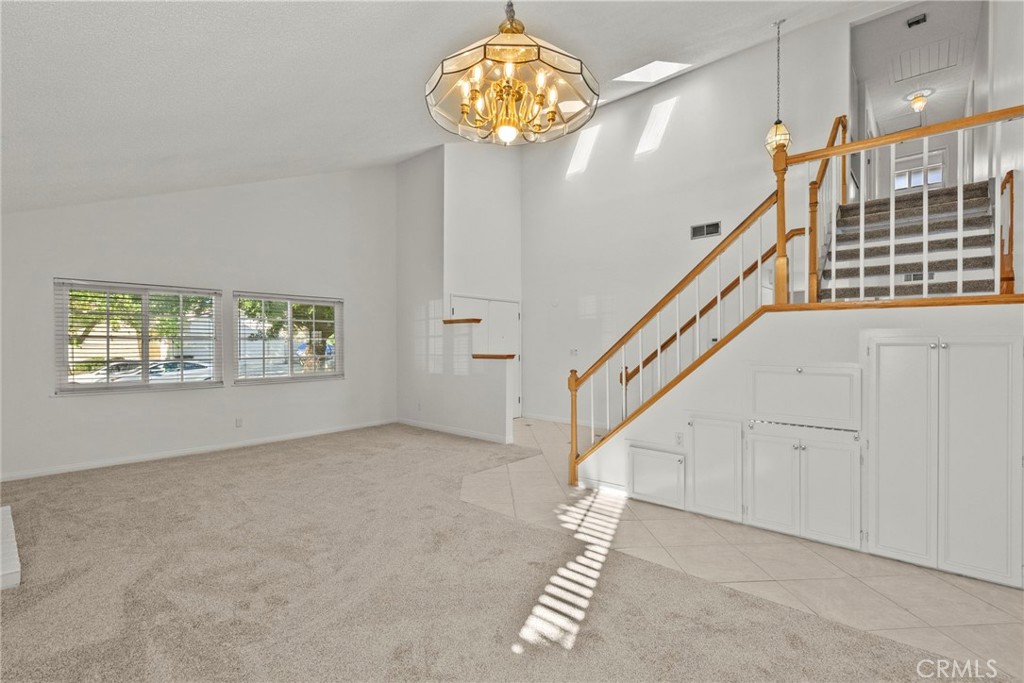 25550 Old Course Way Valencia, CA 91355 - Photo 12 of 48 Dining room view of living room and stairs to front door