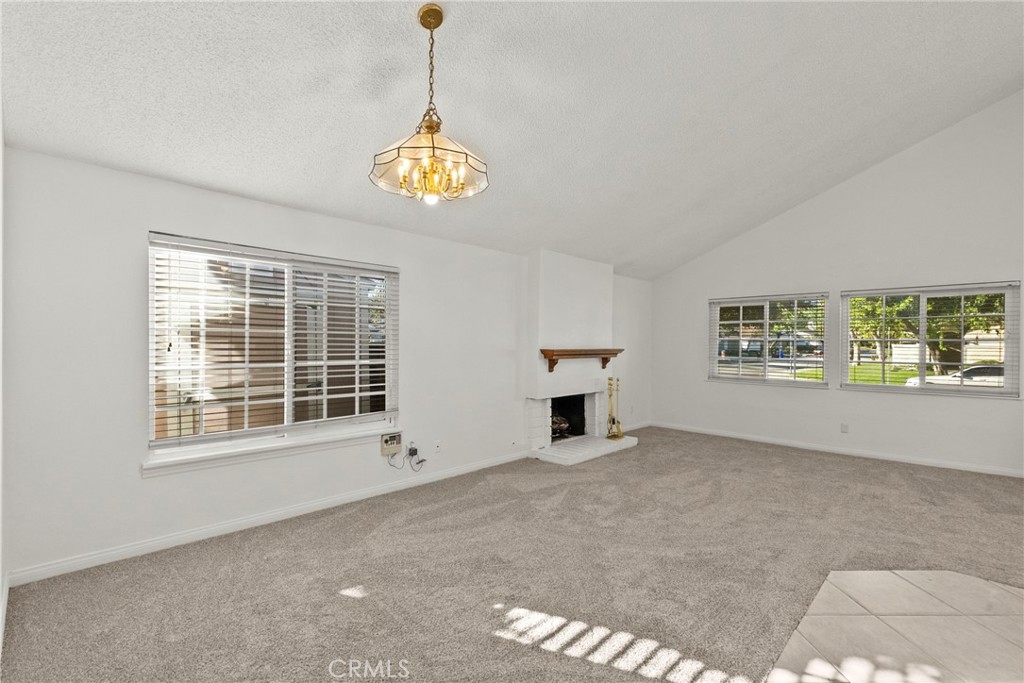 25550 Old Course Way Valencia, CA 91355 - Photo 10 of 48 Angled shot of dining to living room w fireplace