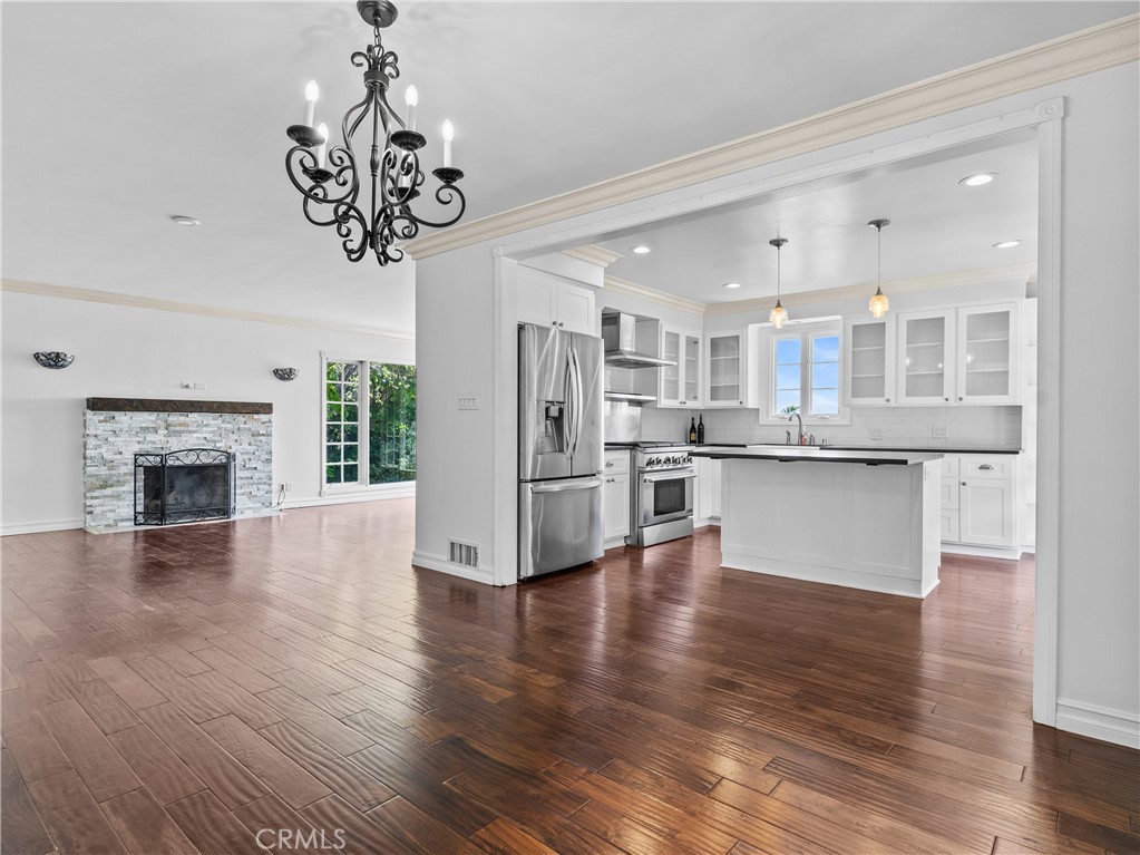6608 Via Siena Rancho Palos Verdes, CA 90275 - Photo 22 of 52 a view of a kitchen with a sink dishwasher a refrigerator and a fireplace