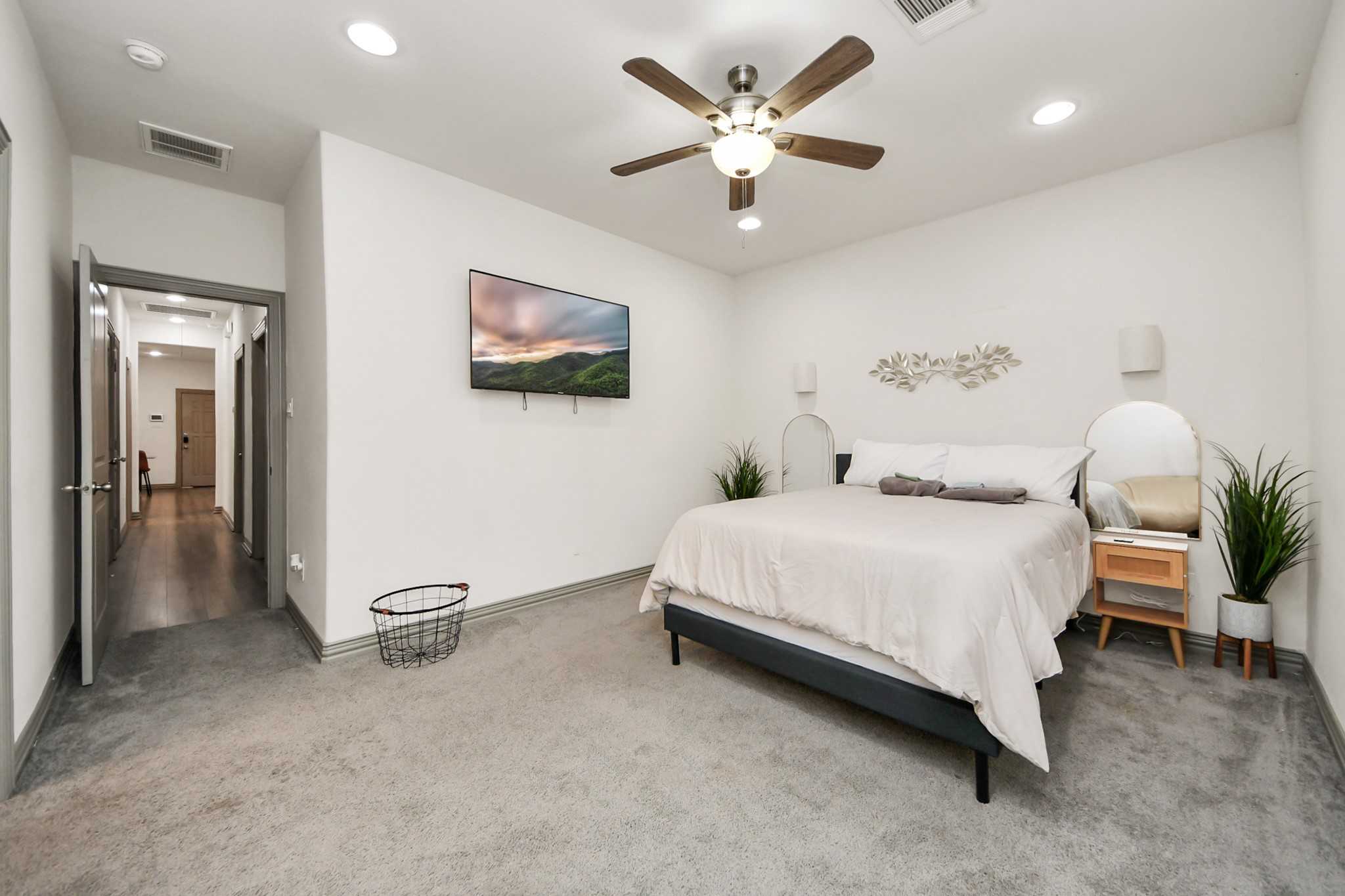 5334 Pershing Street Houston, TX 77033 - Photo 12 of 43 a spacious bedroom with a bed and a chandelier