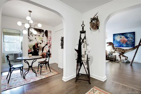 a view of a room with gym equipment and wooden floor